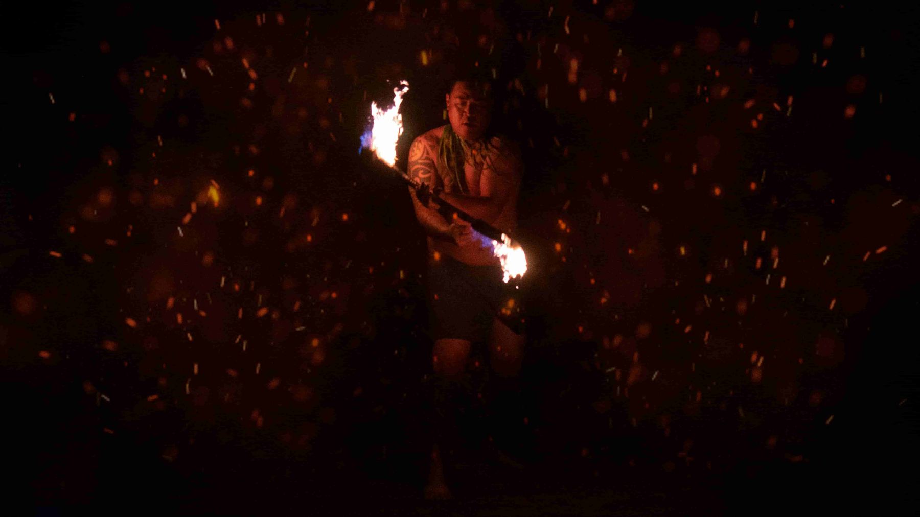Fire knife performer surrounded by sparks on the Big Island