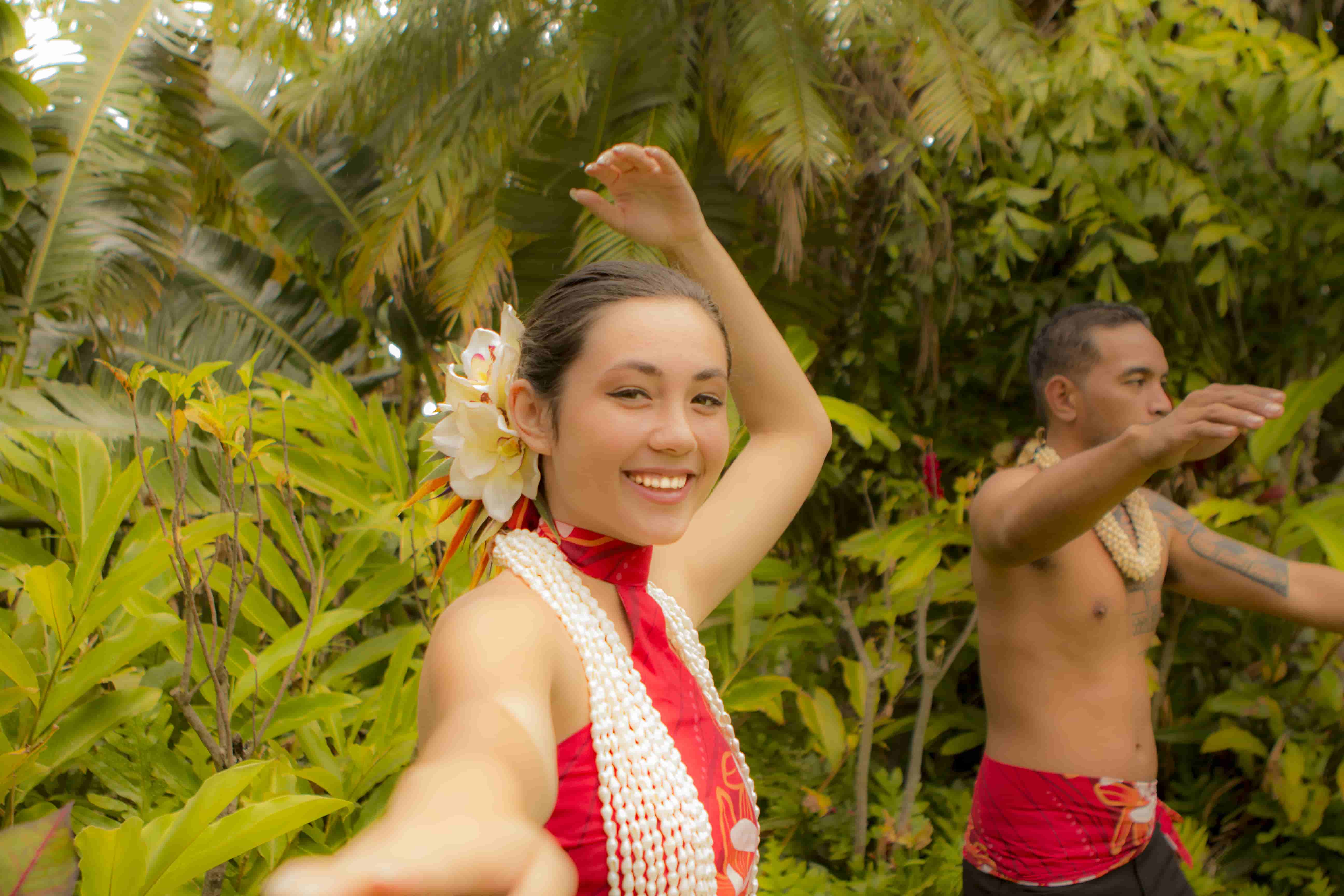 Dancers performing in tropical rainforest setting