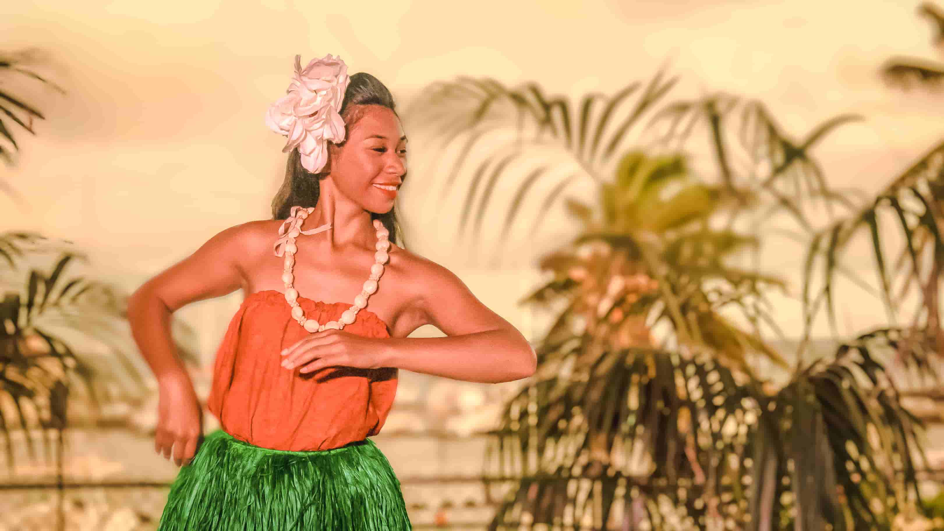 Hula dancer performing at golden sunset
