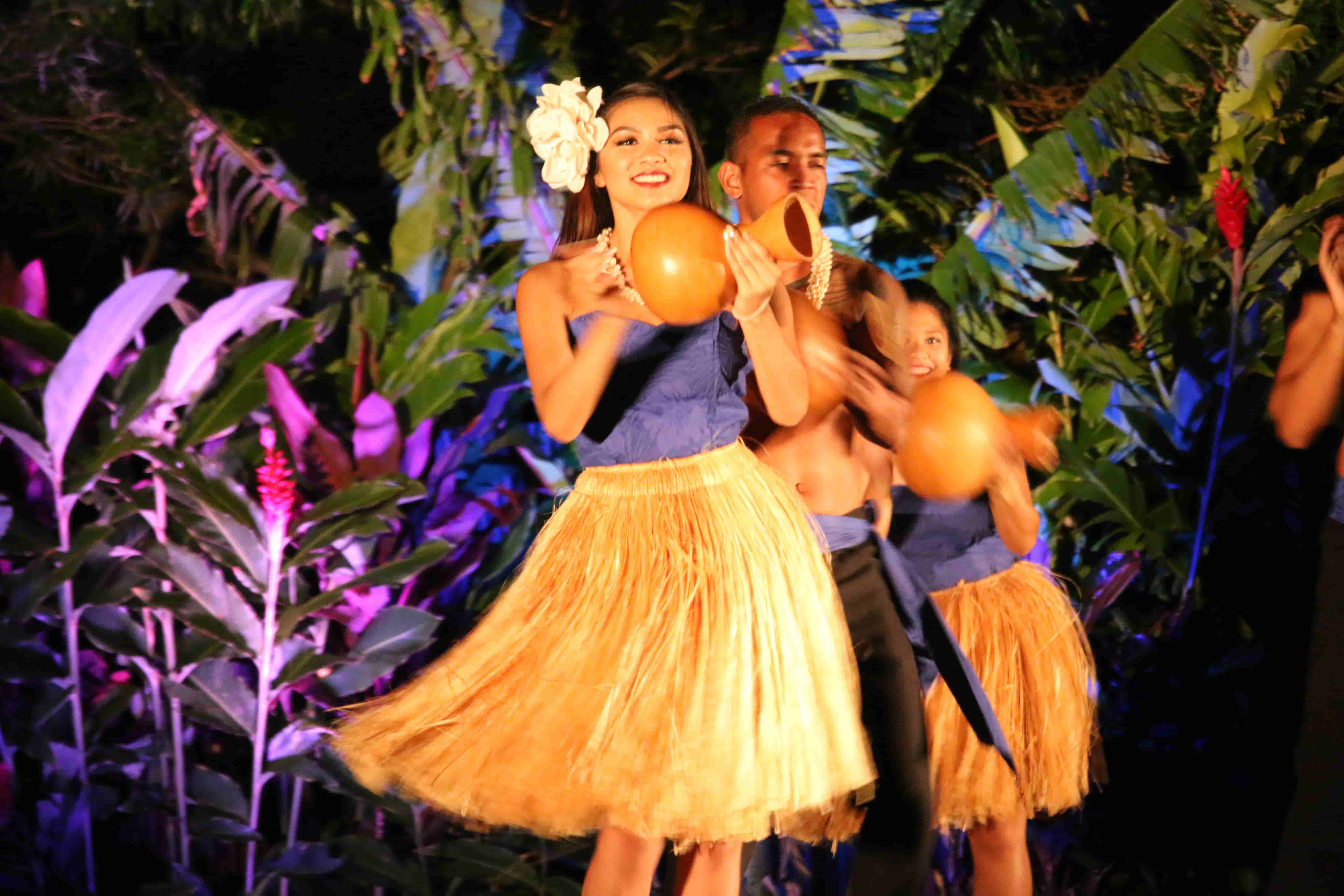 Hula dancers group performing with ipu gourds